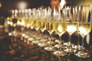 A lot of wine glasses with a cool delicious champagne or white wine at