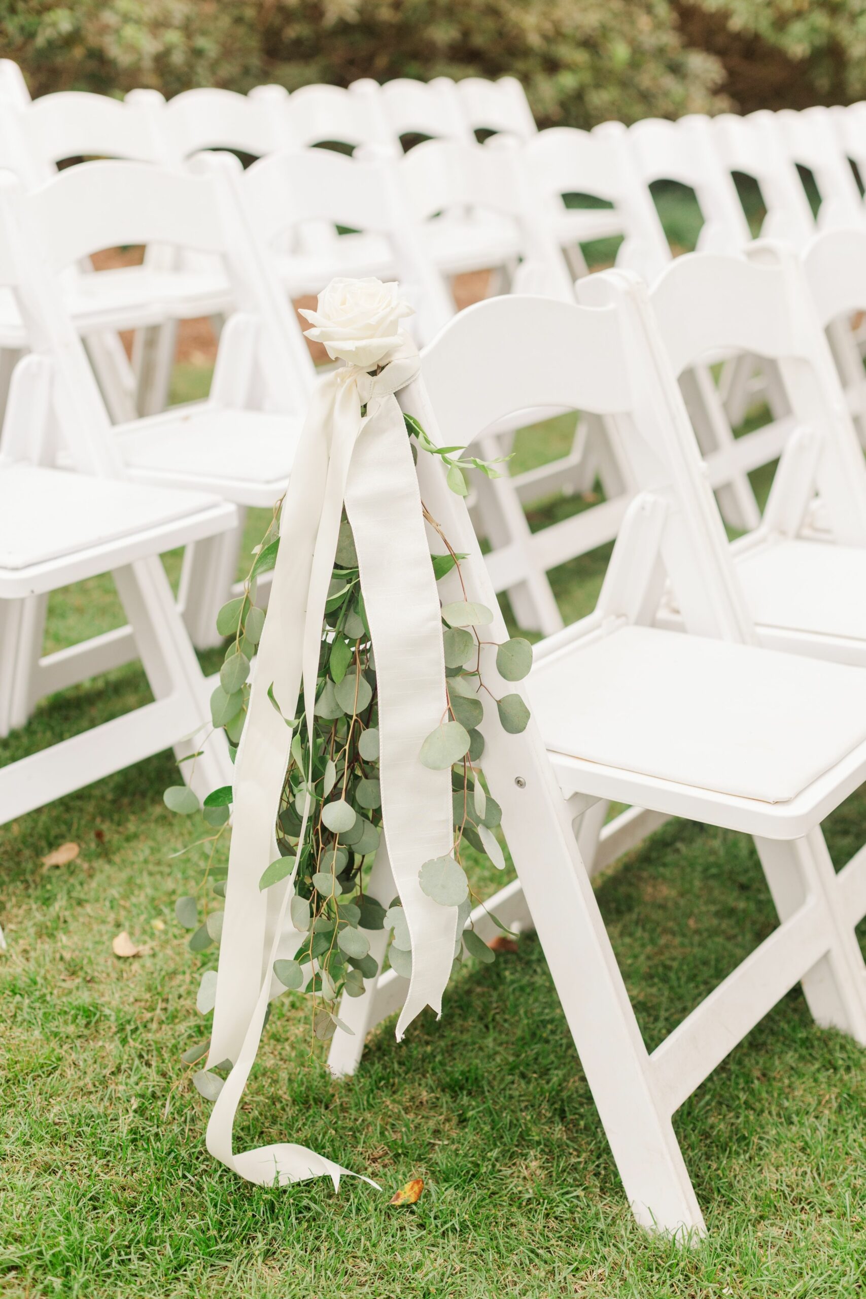 Outdoors chairs decorated with flowers for the wedding